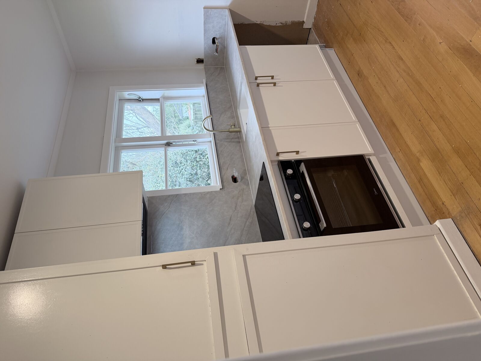 Refreshed kitchen with new stone benchtop and repainted cabinetry, Auckland