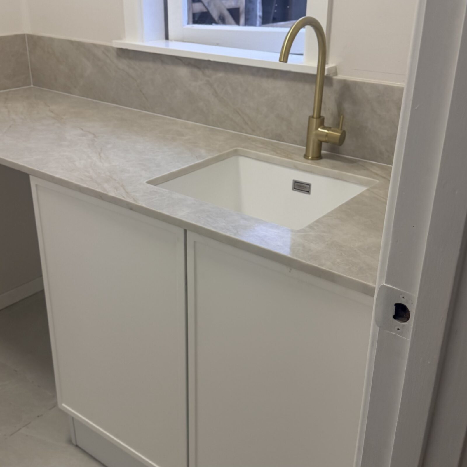 Laundry after renovation with stone benchtop, Auckland