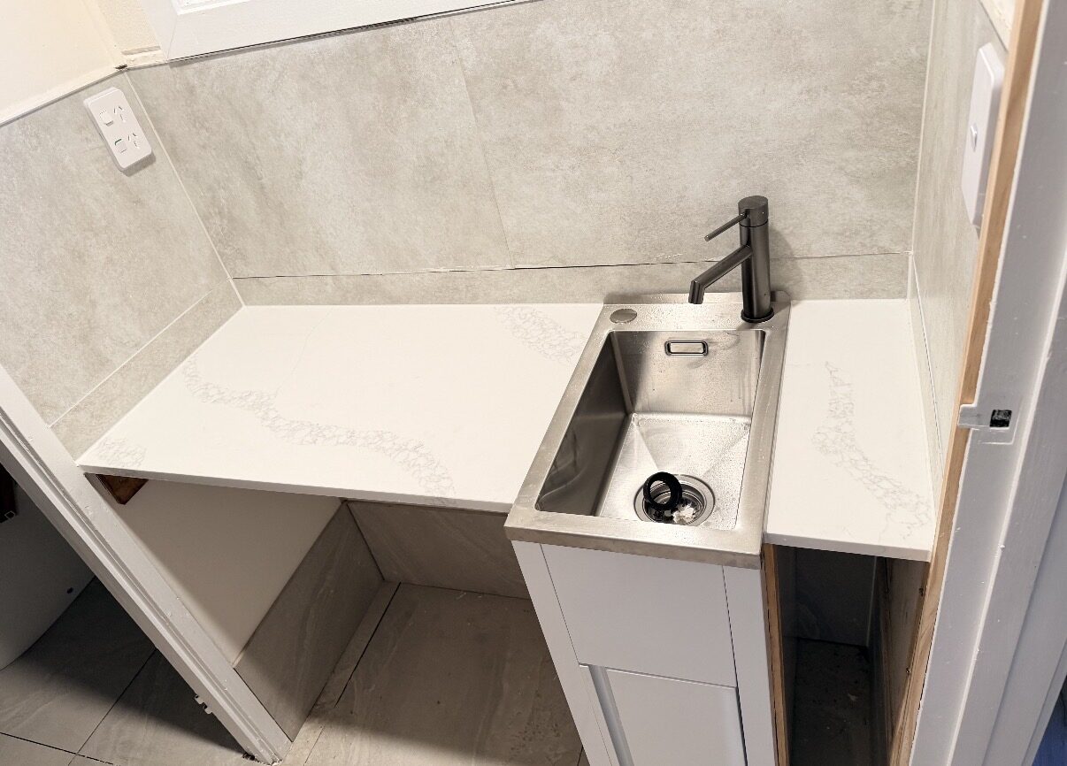 Laundry after renovation with stone benchtop, Auckland
